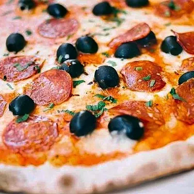The same pizza relit by the Photoroom API: richer, more even colour